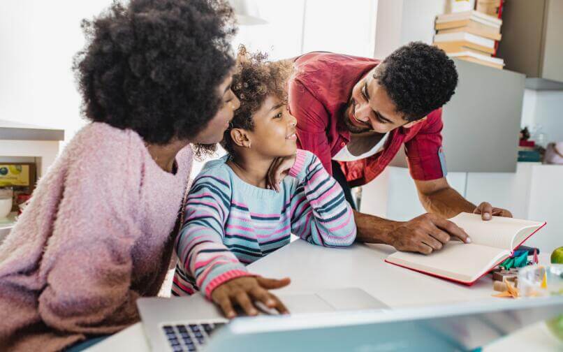 Parents helping their child with their homework.
