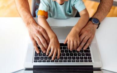 Parent and child on computer.